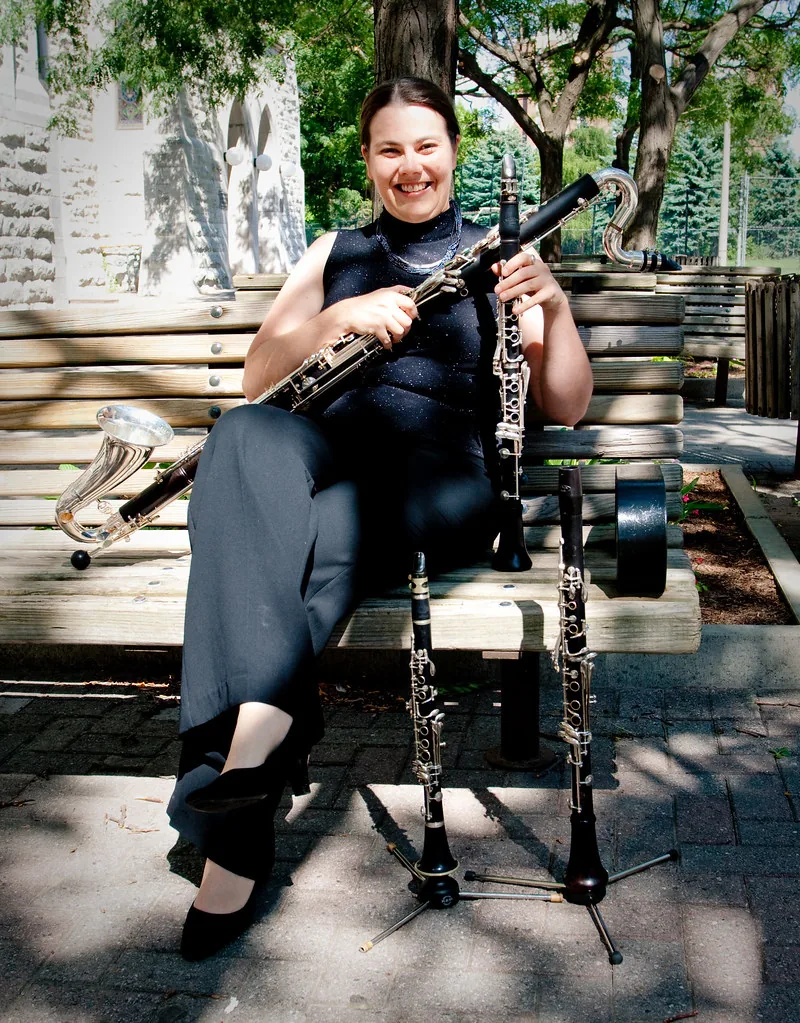 Musician surrounded by clarinets and stands Musician surrounded by clarinets and stands