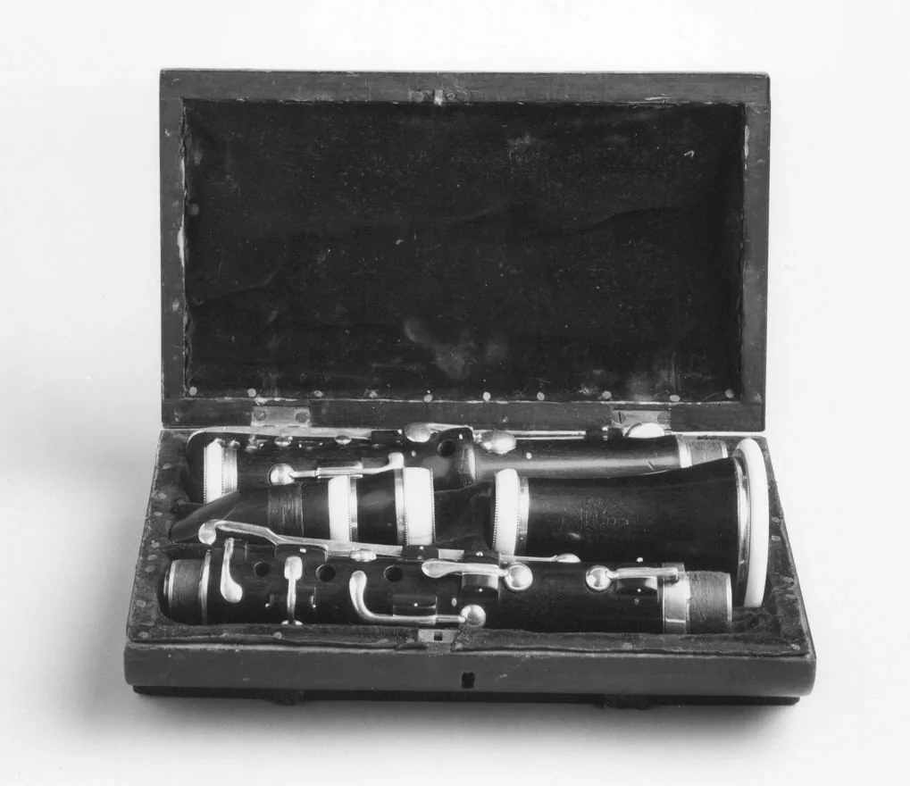 Disassembled clarinet in its open case Disassembled clarinet in its open case