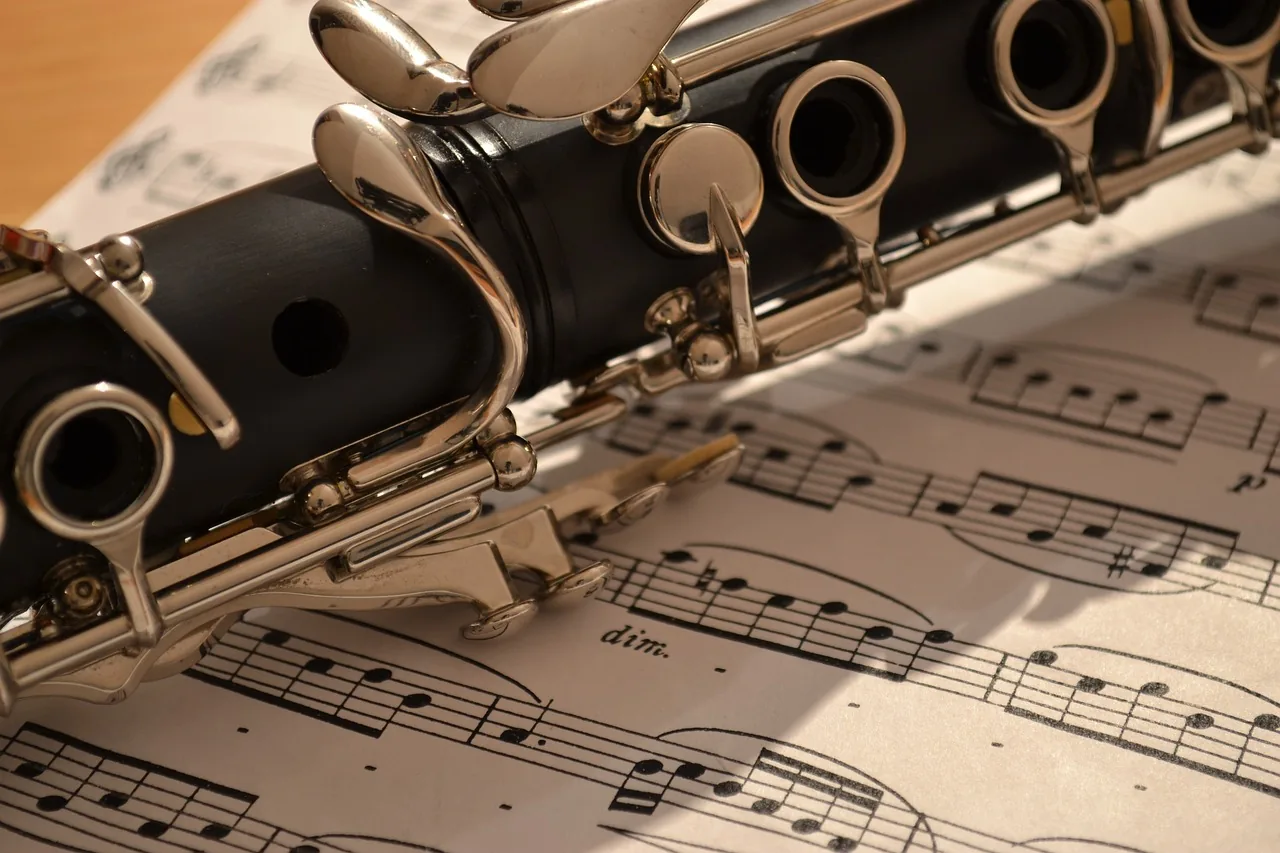 Black clarinet resting on sheet music Black clarinet resting on sheet music