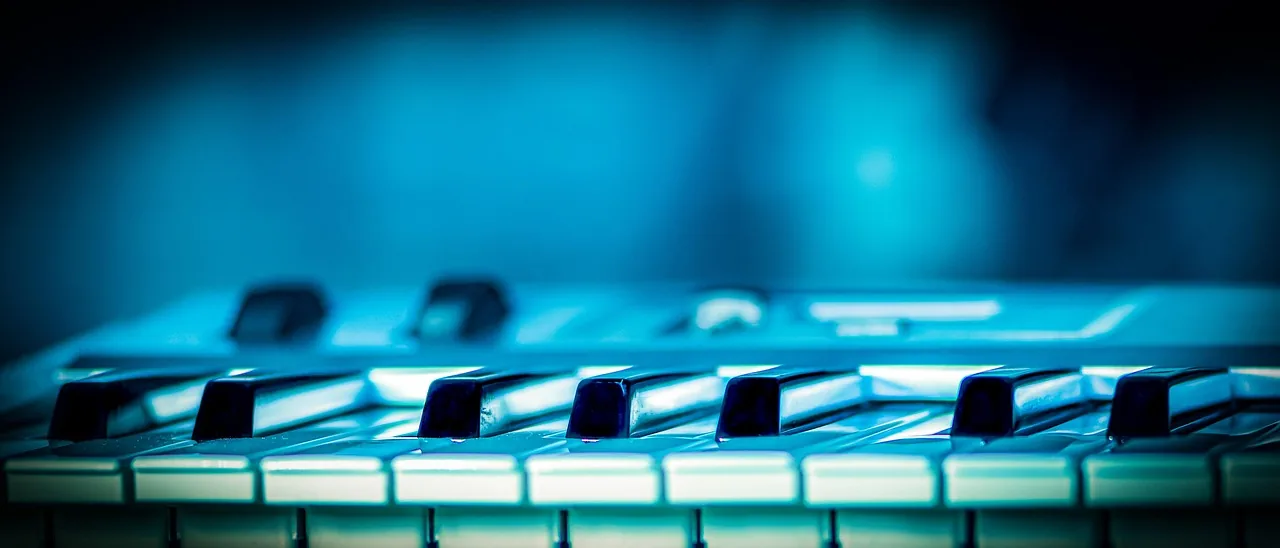 Keyboard keys under blue lighting Keyboard keys under blue lighting