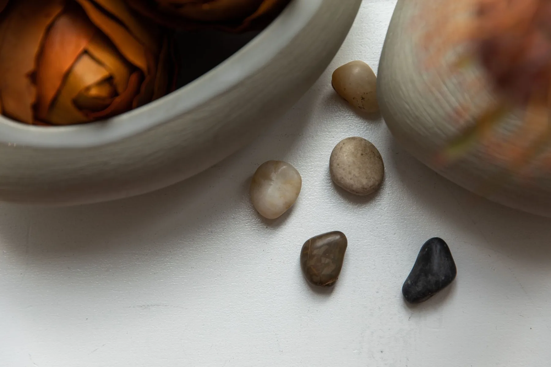 Metal bowls and pebbles on a white surface Metal bowls and pebbles on a white surface