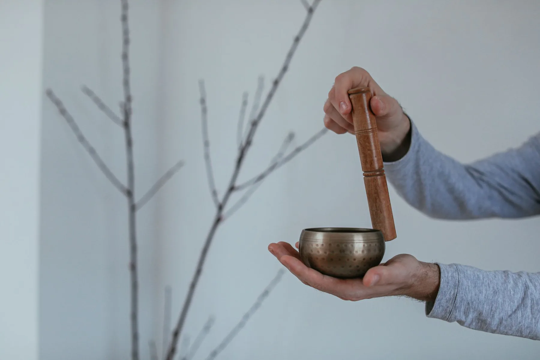 Tibetan singing bowl held in one hand with a mallet Tibetan singing bowl held in one hand with a mallet