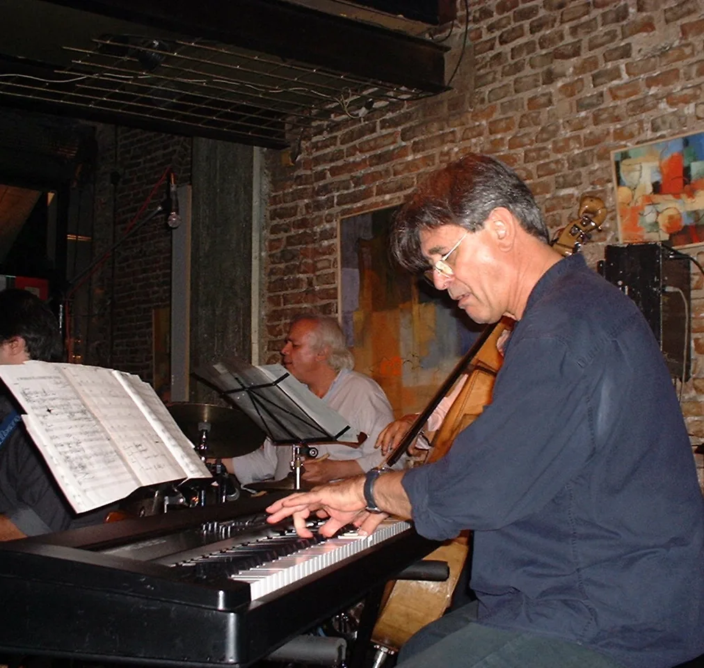 Pianist at the keyboard accompanied by musicians Pianist at the keyboard accompanied by musicians