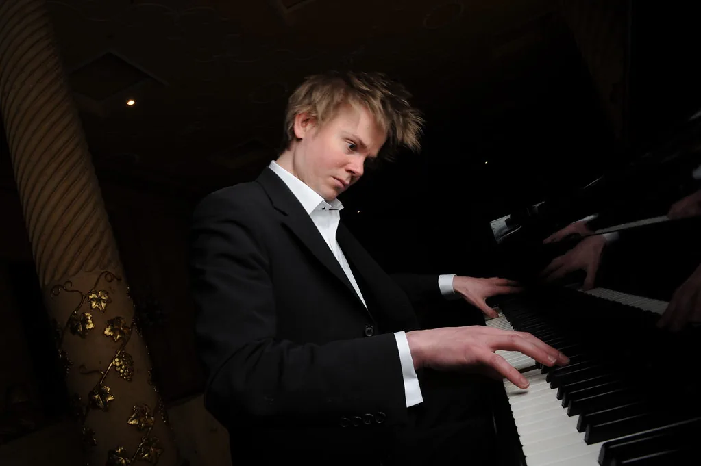 Pianist in a suit playing the piano Pianist in a suit playing the piano
