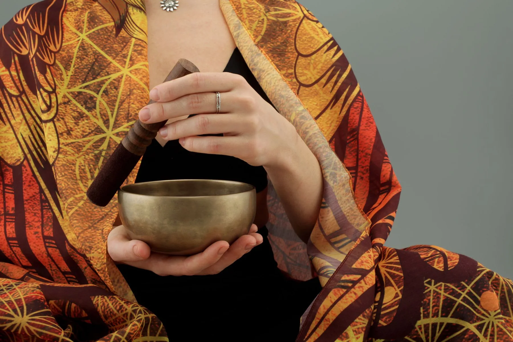 Tibetan singing bowl held with its mallet Tibetan singing bowl held with its mallet