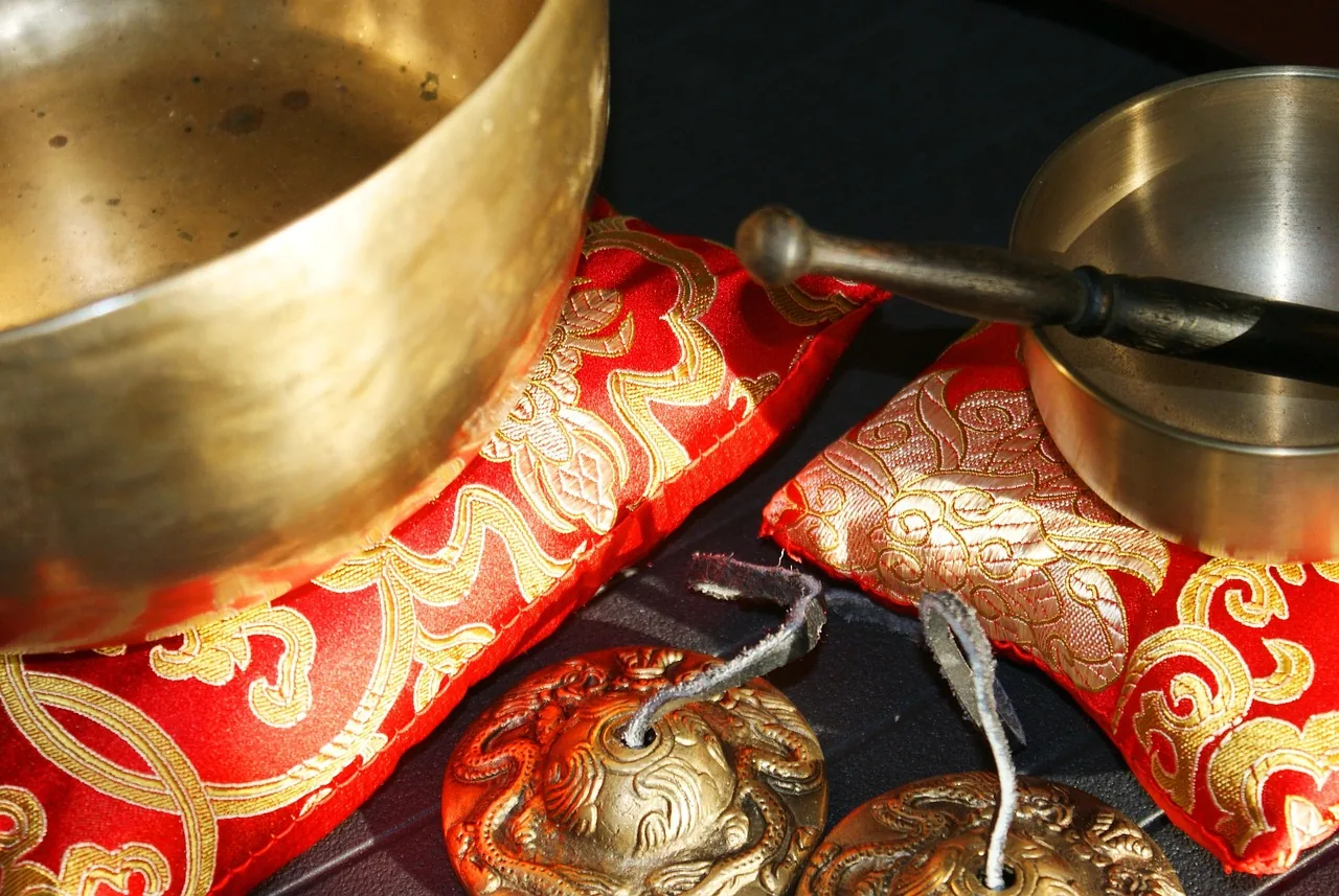 Tibetan bowls on embroidered red cushions Tibetan bowls on embroidered red cushions