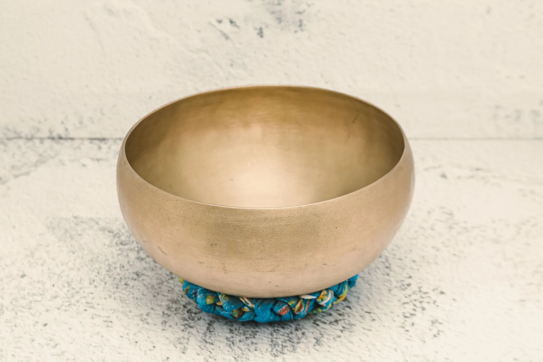 Tibetan singing bowl on a blue cushion