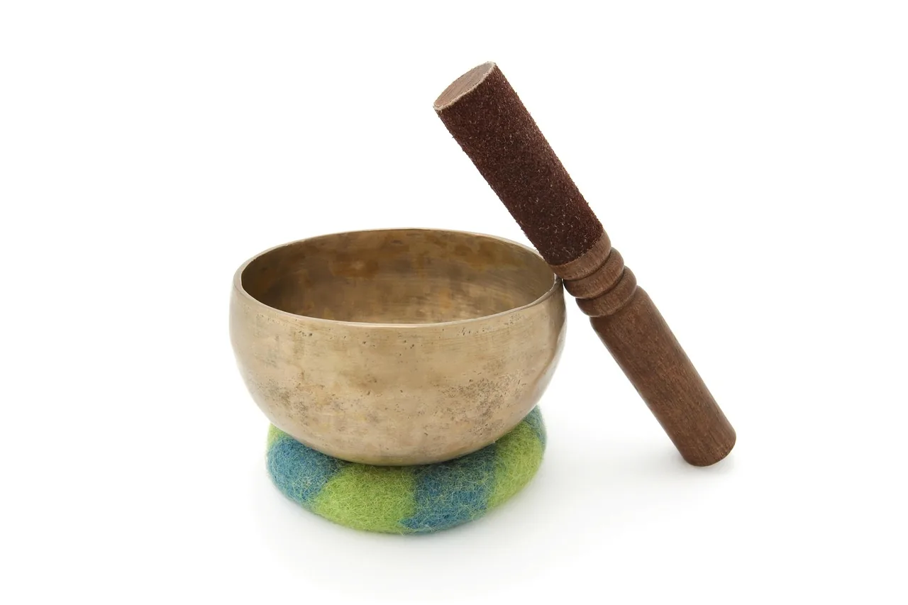 Tibetan singing bowl with mallet on a cushion Tibetan singing bowl with mallet on a cushion
