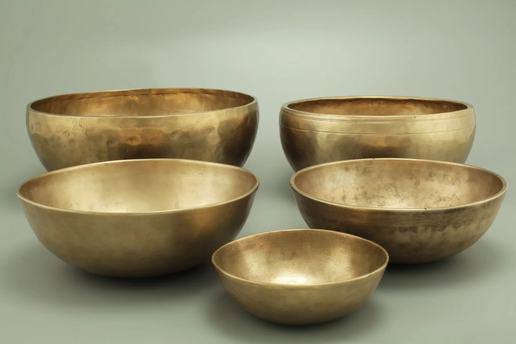Five gold-colored metal Tibetan singing bowls Five gold-colored metal Tibetan singing bowls
