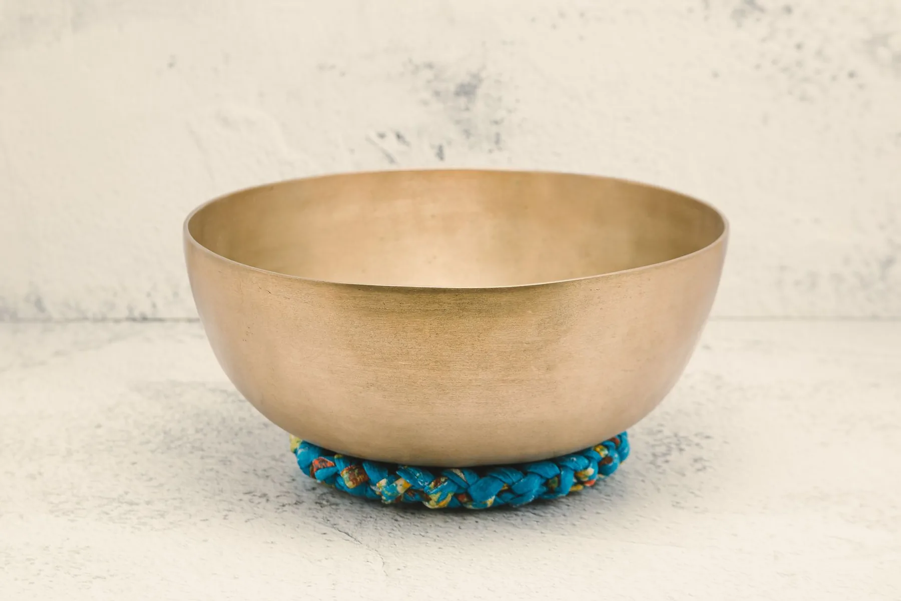 Tibetan singing bowl on a blue woven cushion