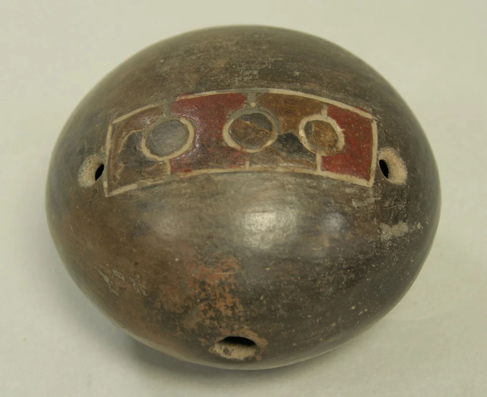 Globular terracotta ocarina with painted patterns