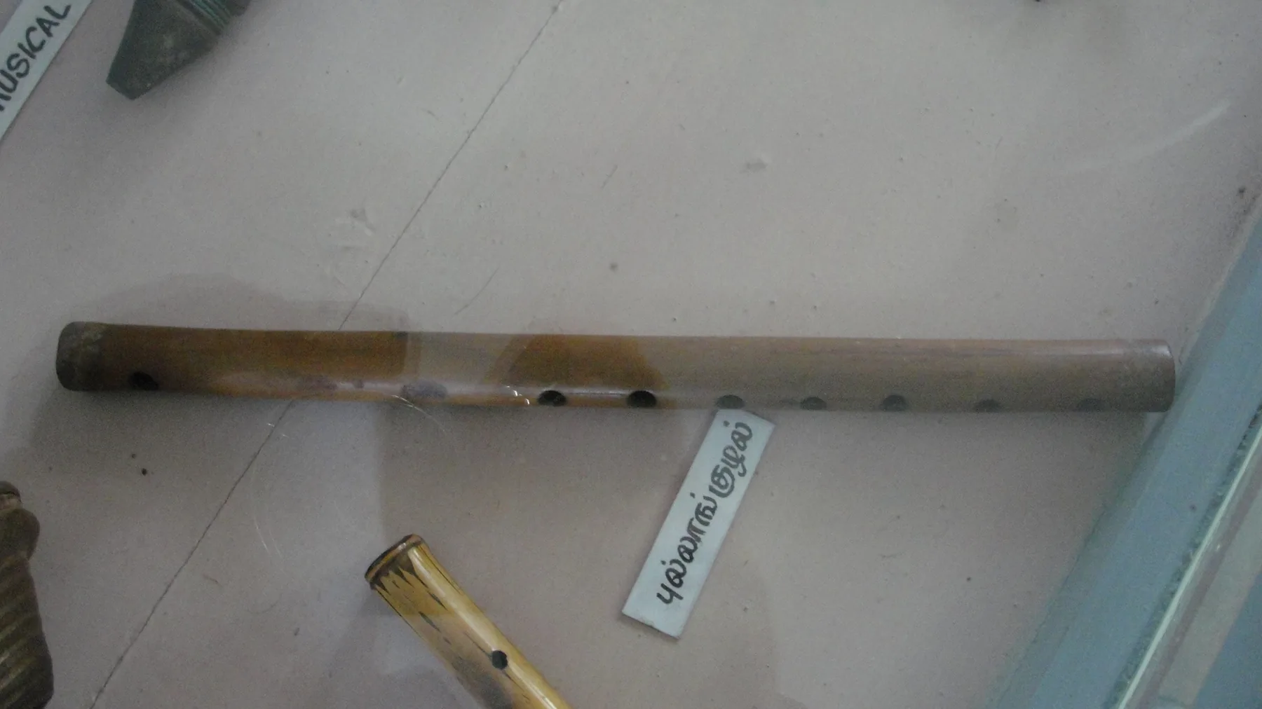 Bamboo flute displayed in a glass case Bamboo flute displayed in a glass case