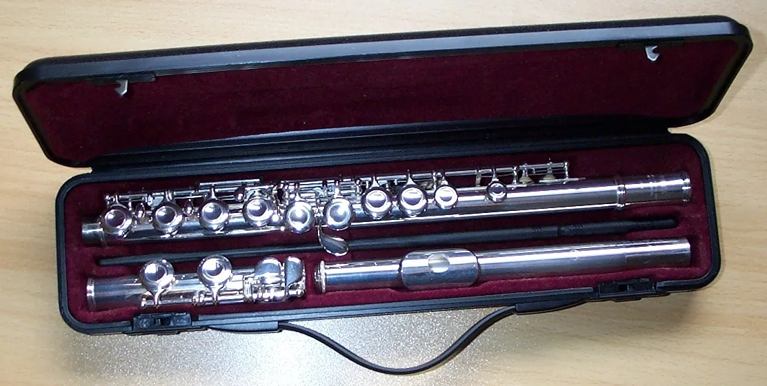 Silver concert flute in its open case Silver concert flute in its open case