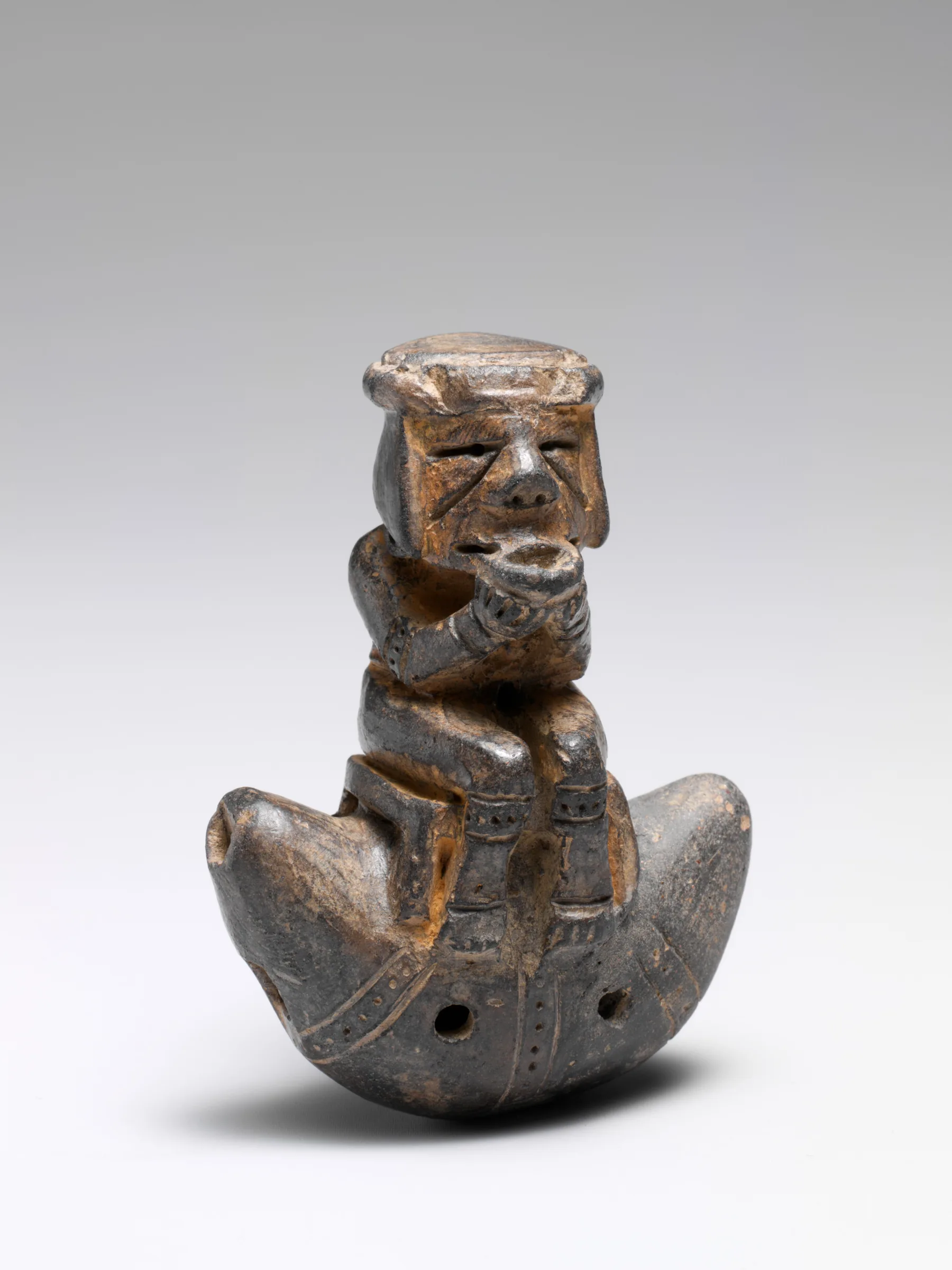 Ceramic ocarina decorated with a sculpted figure Ceramic ocarina decorated with a sculpted figure