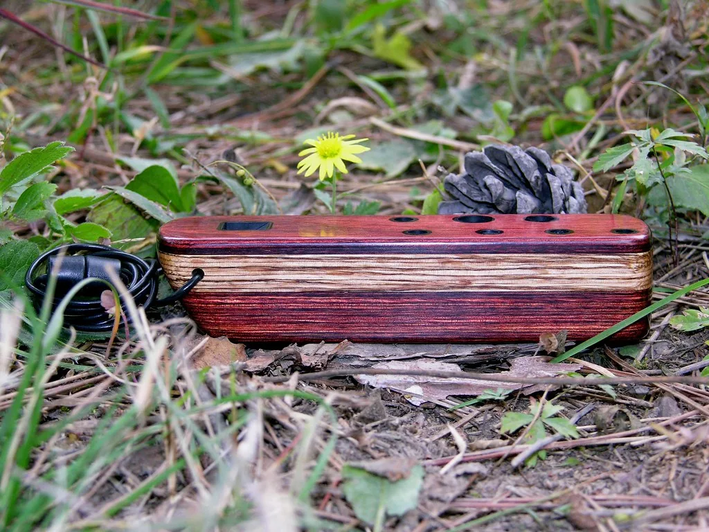Wooden electronic ocarina lying in the grass Wooden electronic ocarina lying in the grass