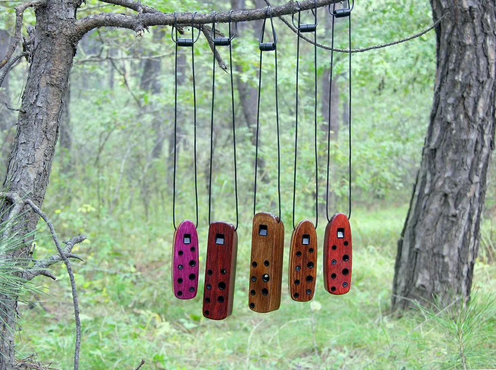 Wooden ocarinas hanging from a branch Wooden ocarinas hanging from a branch