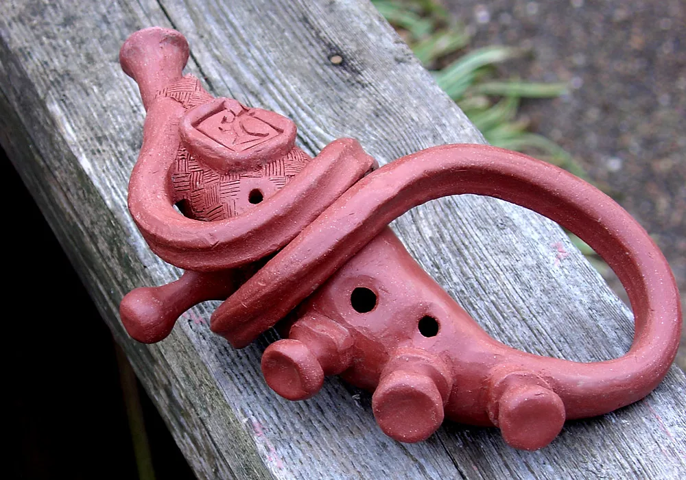 Clay ocarina with sculpted forms Clay ocarina with sculpted forms