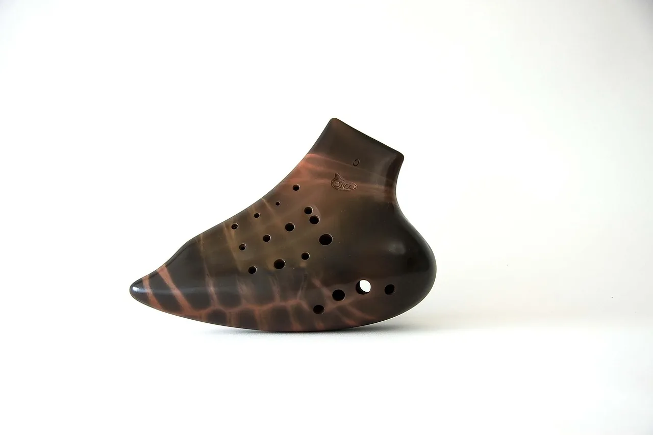 Brown multi-hole ocarina on a white background Brown multi-hole ocarina on a white background