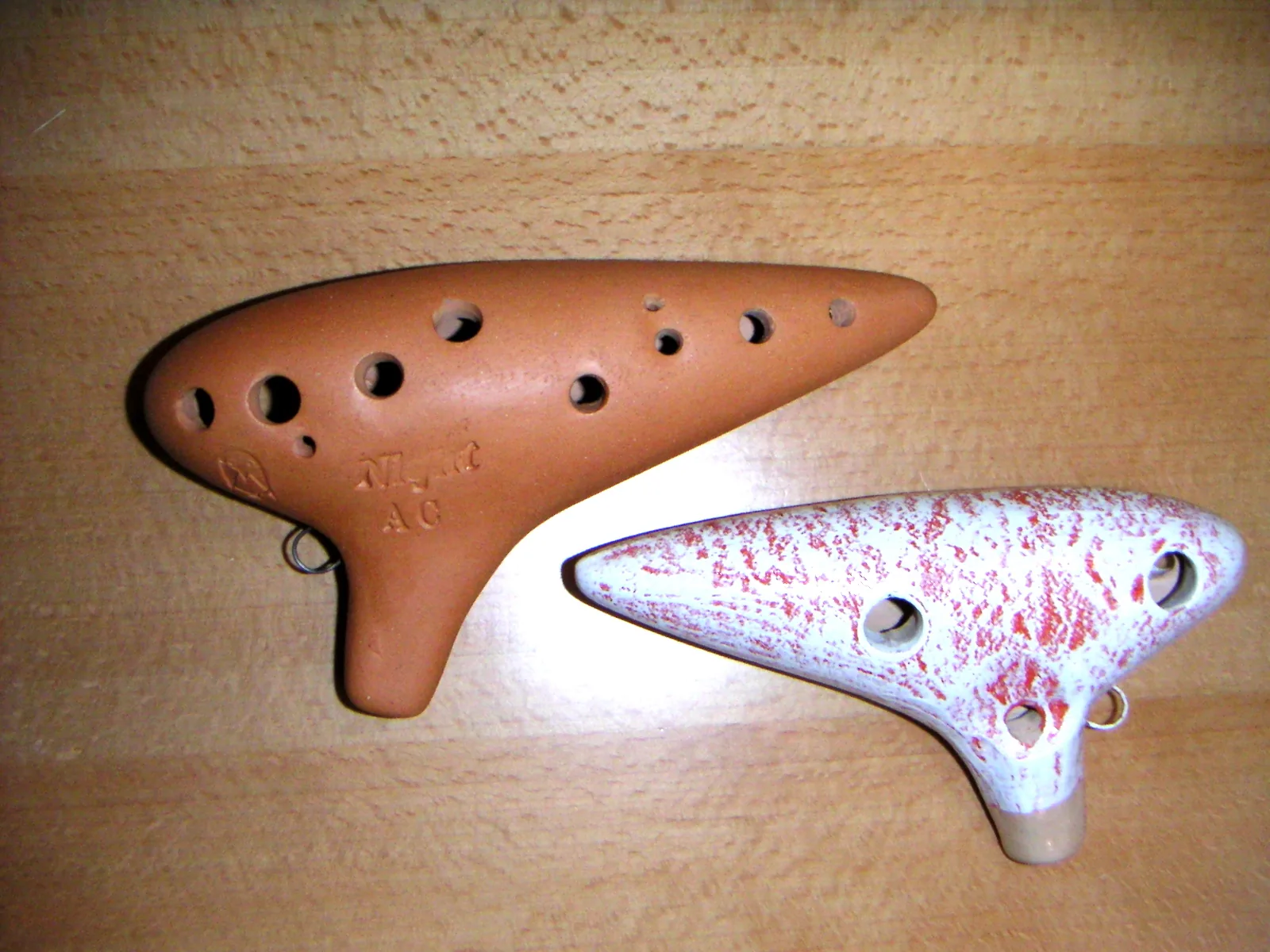 Two ceramic ocarinas on a table Two ceramic ocarinas on a table